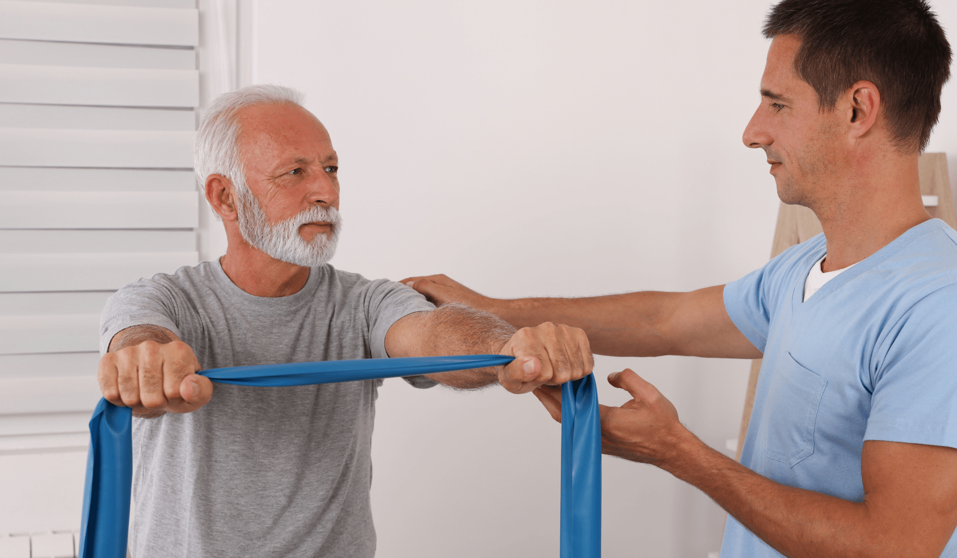elderly man holding a rehabilitation stretching band